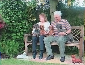 Pat and Maurice with Dog sitting on garden bench